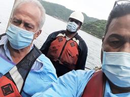 Harbor Master Silila Patane (left), Health official John Fuimaono (right) unnamed man in background
