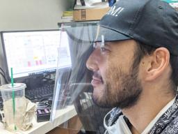 Dr. Eric Muraoka wearing one of his face shields he printed on his 3-D printer