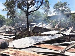 roofing iron smoldering and spread around on the ground
