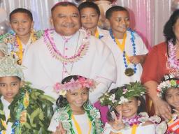 Bishop Kolio Tunamuvao Etuale poses with some of the K5 graduates of Fatuoaiga Montessori School 
