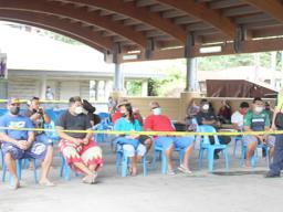 Inter-island wharf with people waiting for cargo under new system
