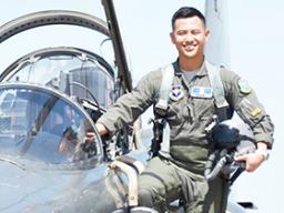 2nd LT Hanyoun Ao Jeong stepping into the cockpit of a jet airplane