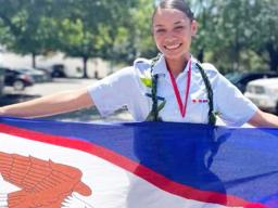 Joanya Tafua holding the American Samoa flag