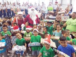 Tafuna ECE students with gifts from Tafuna High School JROTC in background
