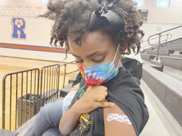 Solome Walker, 9, looks down at her bandage 
