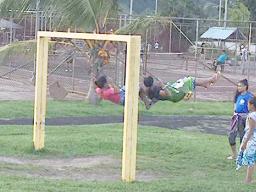 Children swinging on playground equipment at Lions Park