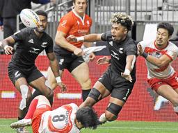 New Zealand's Kitiona Vai offloads the ball 