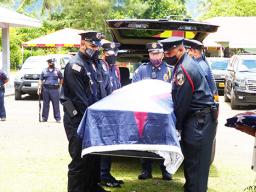 American Samoa flag draped casket of the late former Sen. Tulifua Tini Lam Yuen with police escorte