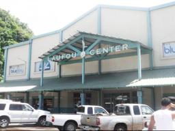 Laufou Shopping Center entrance and parking lot.