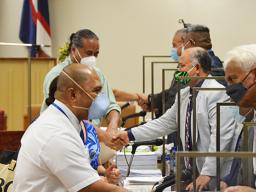 Dr. Akapusi Ledua shakes hands with Rep. Larry Sanitoa