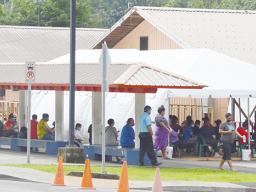 People waiting in the LBJ emergency room triage tents