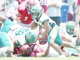 Leone Lions running back Wylan Faga avoids a pile-up and continues to run