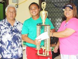 Pisita Lui of Lion Heart’s Girls 13-15 team receives the championship trophy