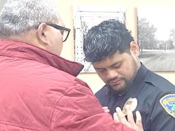 Georgia Mageo receiving his badge from his father.