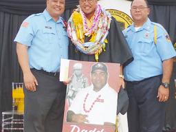 Malachi with portrait of his father and two firefighters