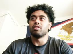 Vavae Malepeai with an American Samoa flag in the background