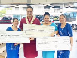 Manumalo presents checks for Tonga fundraising