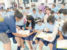 Manumalo Academy 3rd graders look through their new dictionaries