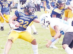 Marist Crusaders running back Kanai Satele trying to avoid a tackle from a Samoana Shark defender 