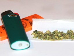 Marijuana buds, rolling papers and lighter