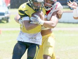 Tafuna Warriors Francisco Mauigoa and a Nuuuli Wildcat ball carrier