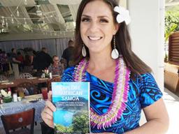 Melinda Laura Clayville holding the guidebook 