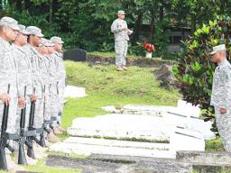 soldiers saluting graves on Memorial Day in American Samoa