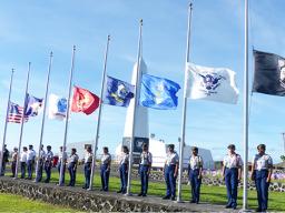 U.S.and American Samoa flags along with flags of the services at half staff