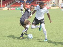 Milo Tiatia (left) of American Samoa battles for possession