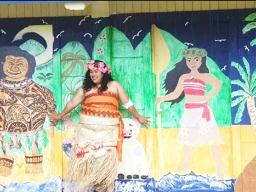 American Samoa’s very own “Moana” — standing in front of classroom doors painted with the likeness of Disney’s Maui and Moana