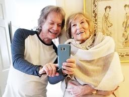 Leland Stein, left, takes a photo with his mother Sondra Green