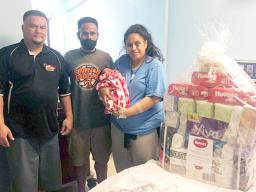  Lisale and Fiatuina Polevia with their newborn and a representative from Pacific Independent Distributors, Inc. 