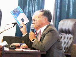  Samana Semo Ve’ave’a holds up for visual display the NOAA weather radio,
