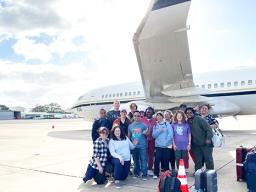 NuWest traveling healthcare workers posing by airplane in American Samoa