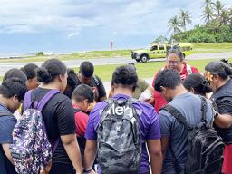 Olosega Elementary students bow their heads in prayer