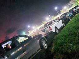 Cars lined up in the dark for vaccination drive thru