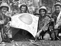 Trophy: U.S. troops hold a Japanese flag captured in July 1944 during the Battle of Saipan