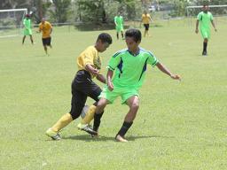 A Pago Youth players tries to dribble away from a Taputimu player