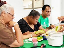Parents with their special needs children learning how to make tacos