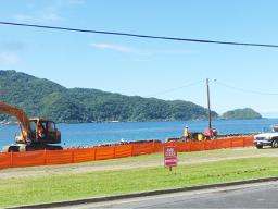 Park closed sign and red construction fencing along the shoreline
