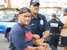 Defendant, Pati Lepou with a police officer 
