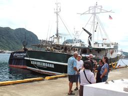 Facing the camera, Carlos Sanchez, a co-owner of several US- American Samoa based longliners is seen with the PBS TV crew.