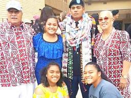 Pfc. Washington Pou Ameperosa stands for a picture with three sisters and his grandparents 