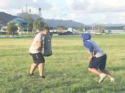Two high school football players working out