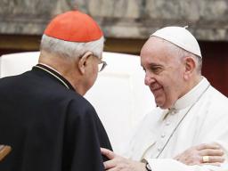 Pope Francis exchanges greetings with Cardinal Angelo Sodano, left