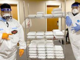 Protected workers deliver meals at a quarantine site in Am Samoa