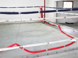 Ring rope cut and laying on floor of boxing ring
