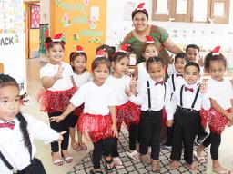 Room 4 students at Fatuoaiga Montessori School with their teacher all in Christmas finery