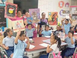 1st grade students and teachers with their new books and posters
