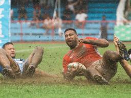Cooper Vuna scores a try against Samoa on muddy field.
